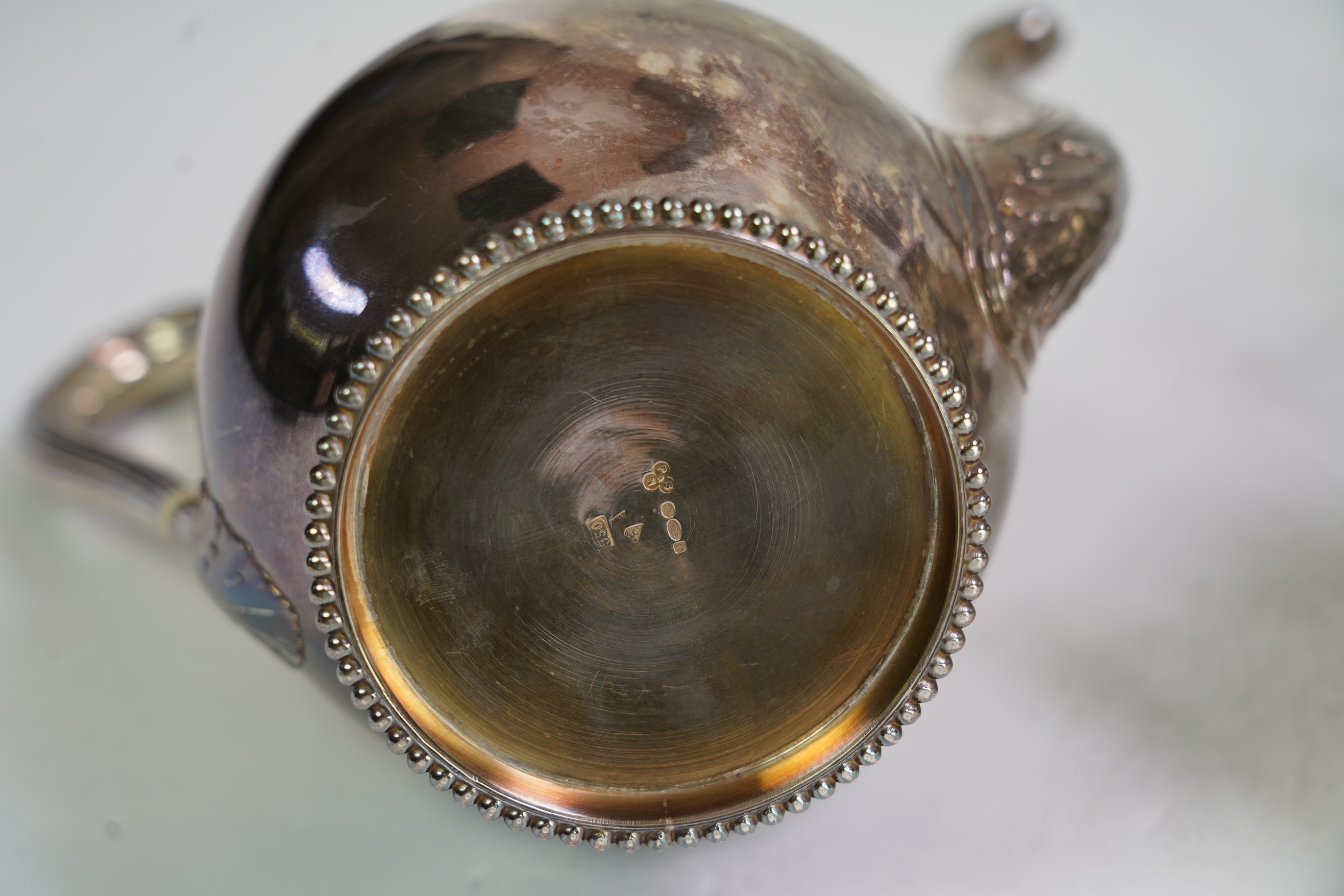 An early 20th century French silver three piece tea and coffee set, comprising a teapot, coffee pot and two handled sugar bowl, by Henin & Cie